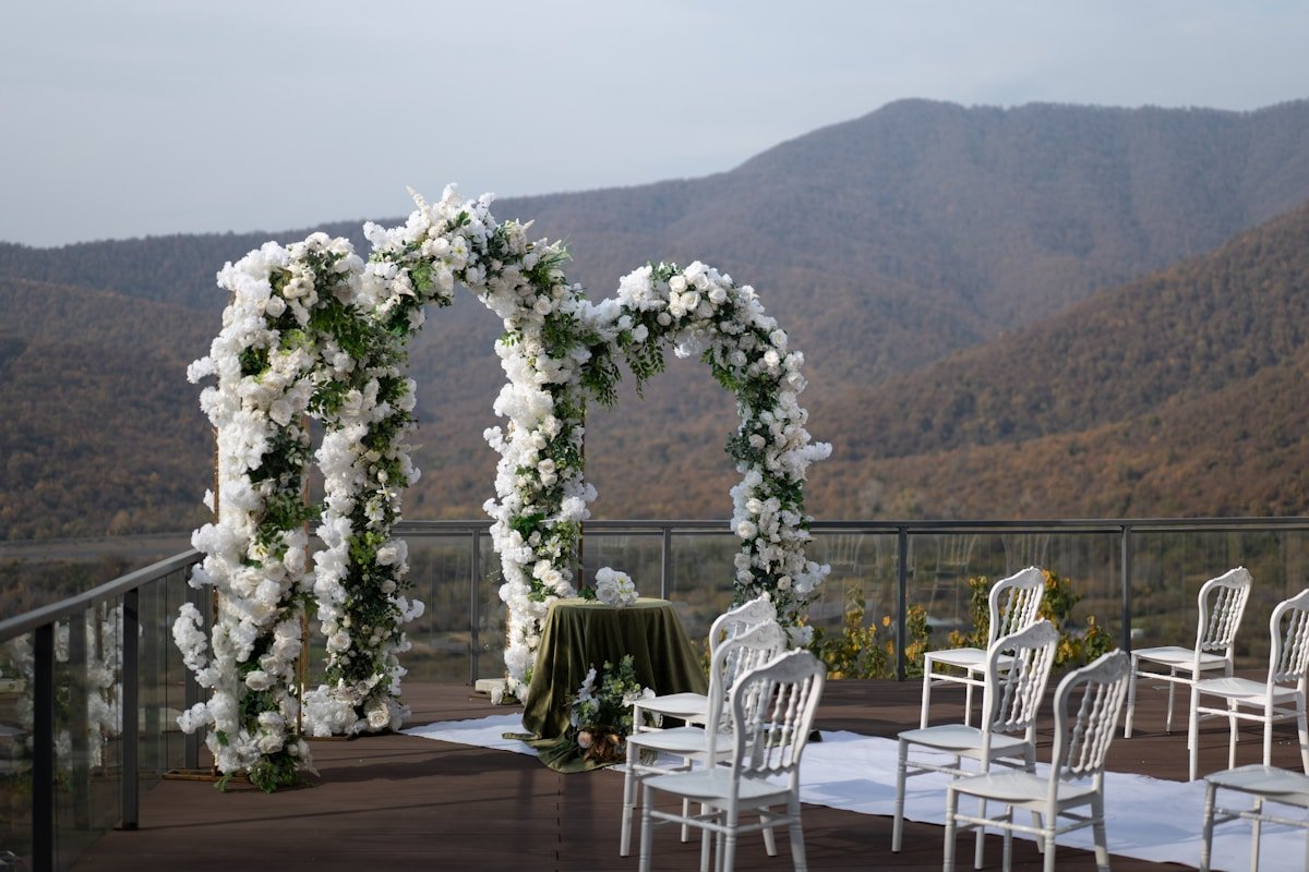 Lush Floral Arch at Outdoor Ceremony — Ultimate Party Rentals