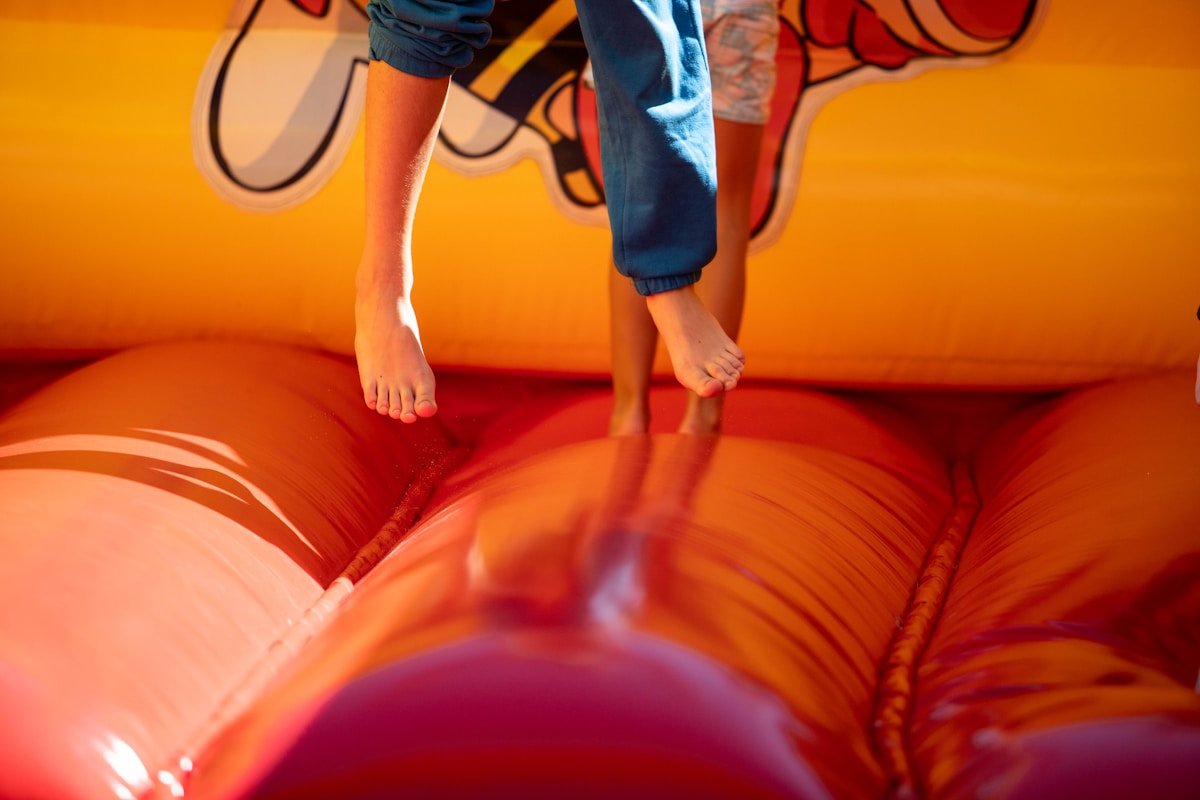 Kids Playing in Colorful Bounce House — Ultimate Party Rentals